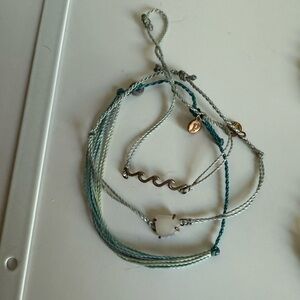 3 pura vida bracelets.
1 wave
1 stone
1 string